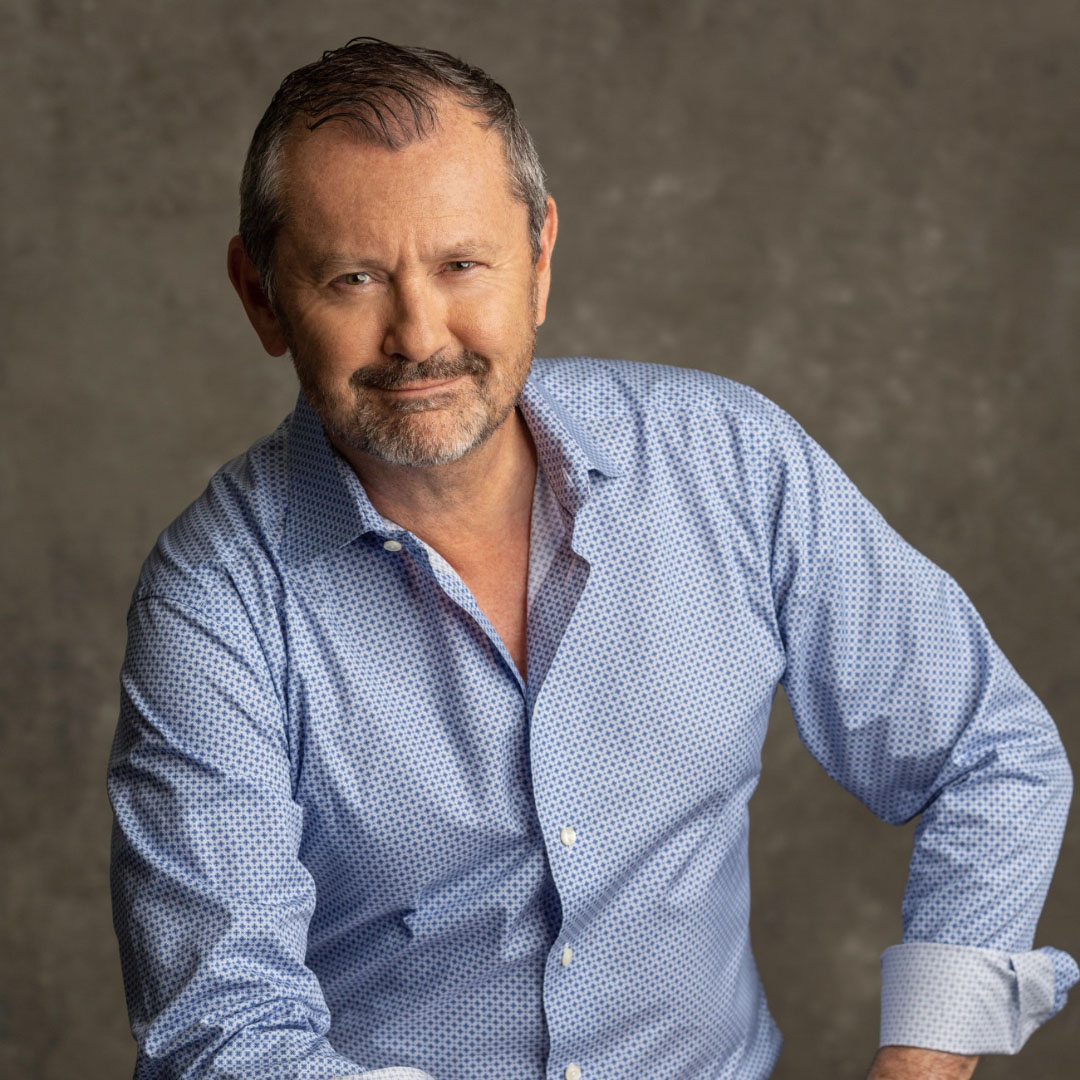 Agent, Kevin Wakelin poses for the camera wearing a blue shirt