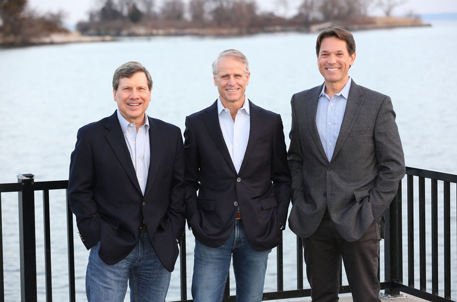 View of Jon Wendell, Sterling Lapinski, and David Tenney standing near a body of water