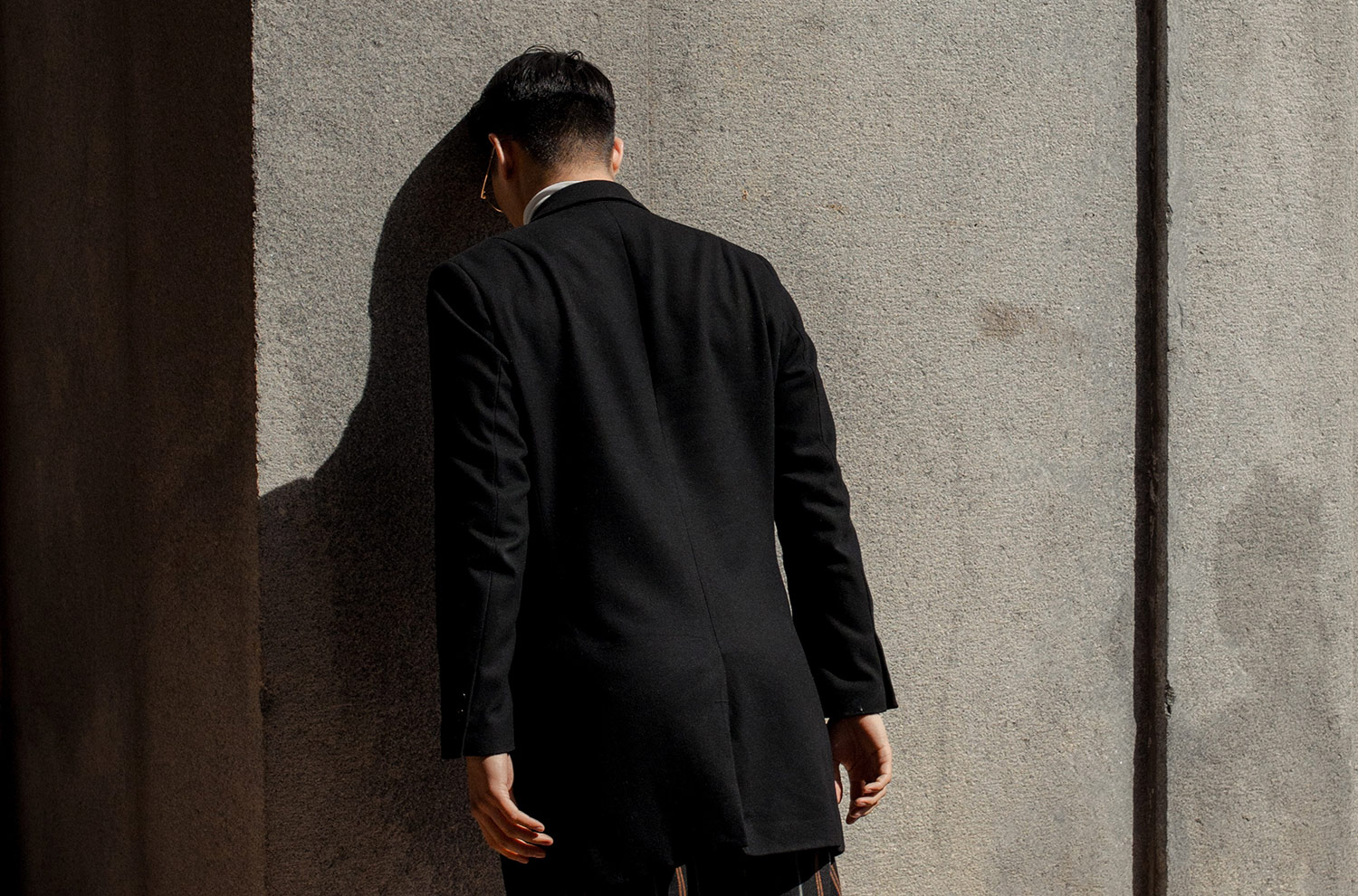 Image of Person leaning their head against a wall