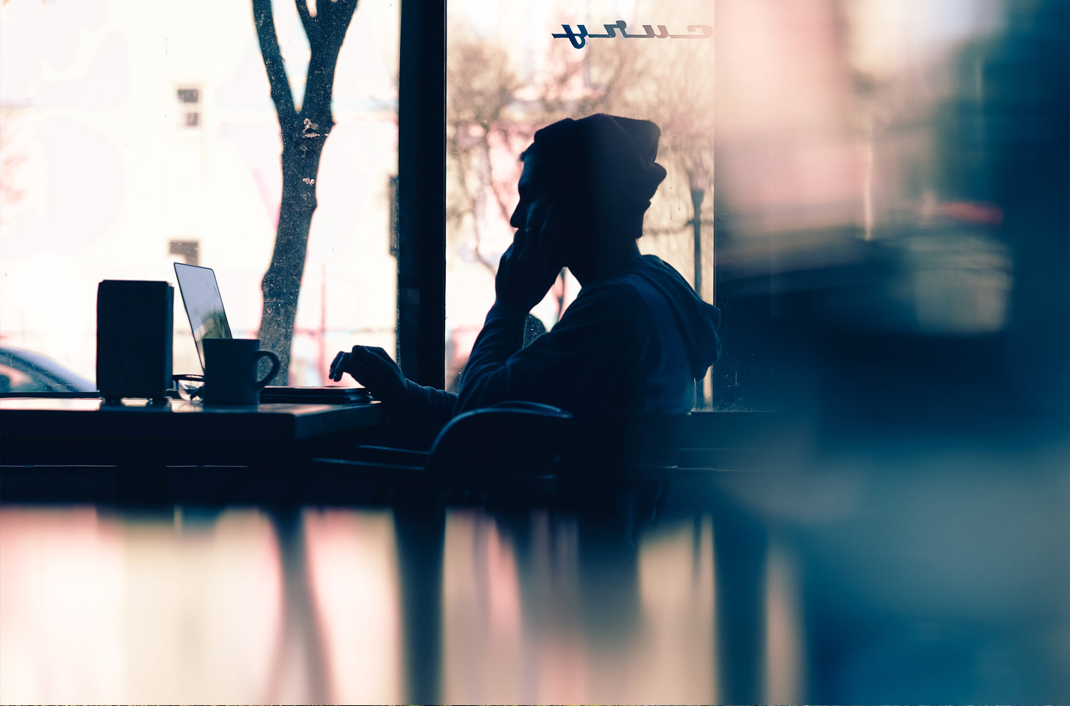 Silhouette of person using laptop @Hannah Wei at Unsplash