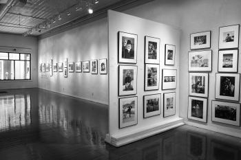 Interior view of Monroe Gallery of Photography, white walls and black and white photography are visible