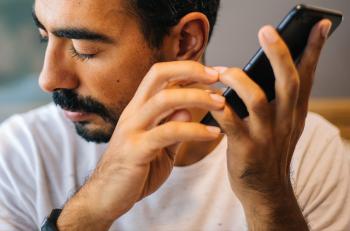 A person holding a phone to their ear