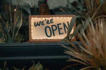 Business window displaying an 'open' sign